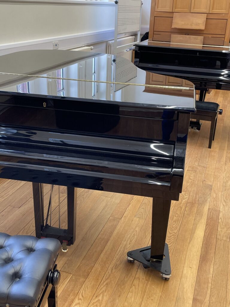Inspired to Inspire? 2 Inspired to inspire, so many of my students have done this. Two shiny black grand pianos in a music hall.