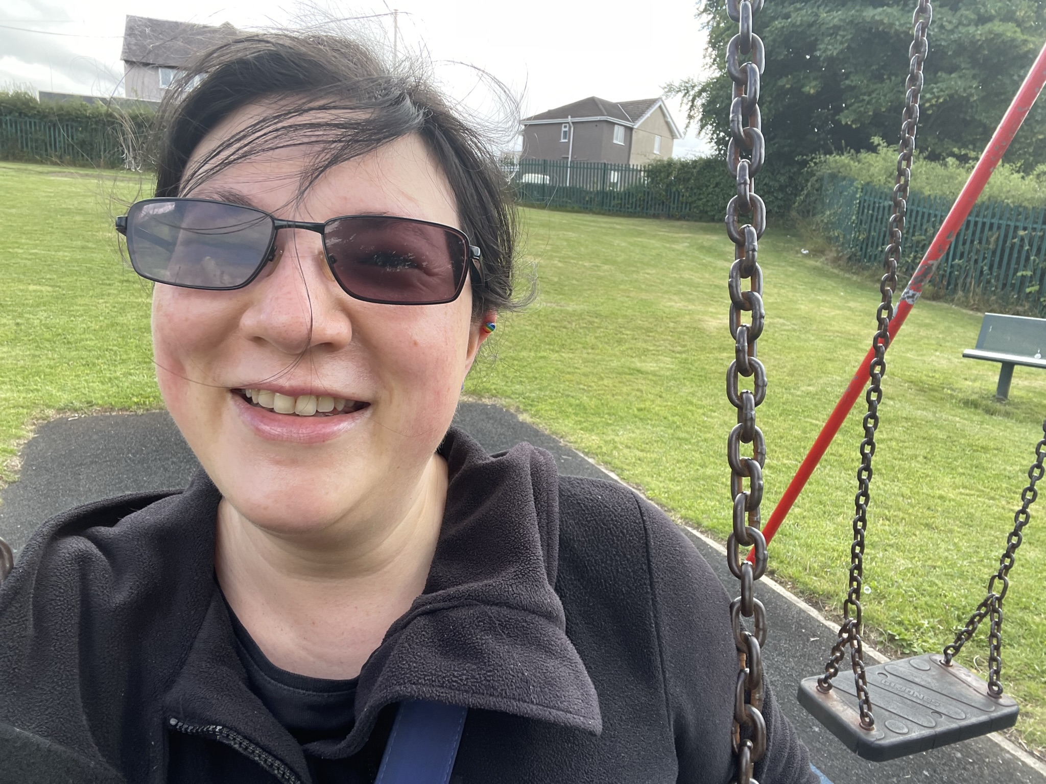 Making the Most of the Summer! 1 A selfie of me grinning whilst on a swing at the local park.