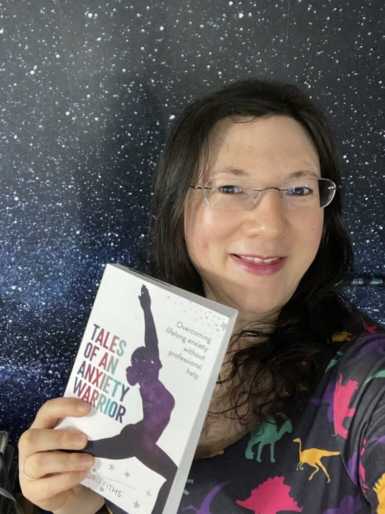 Summer Fun Begins! 7 A selfie of me in my dinosaur dress, holding my book to the camera!