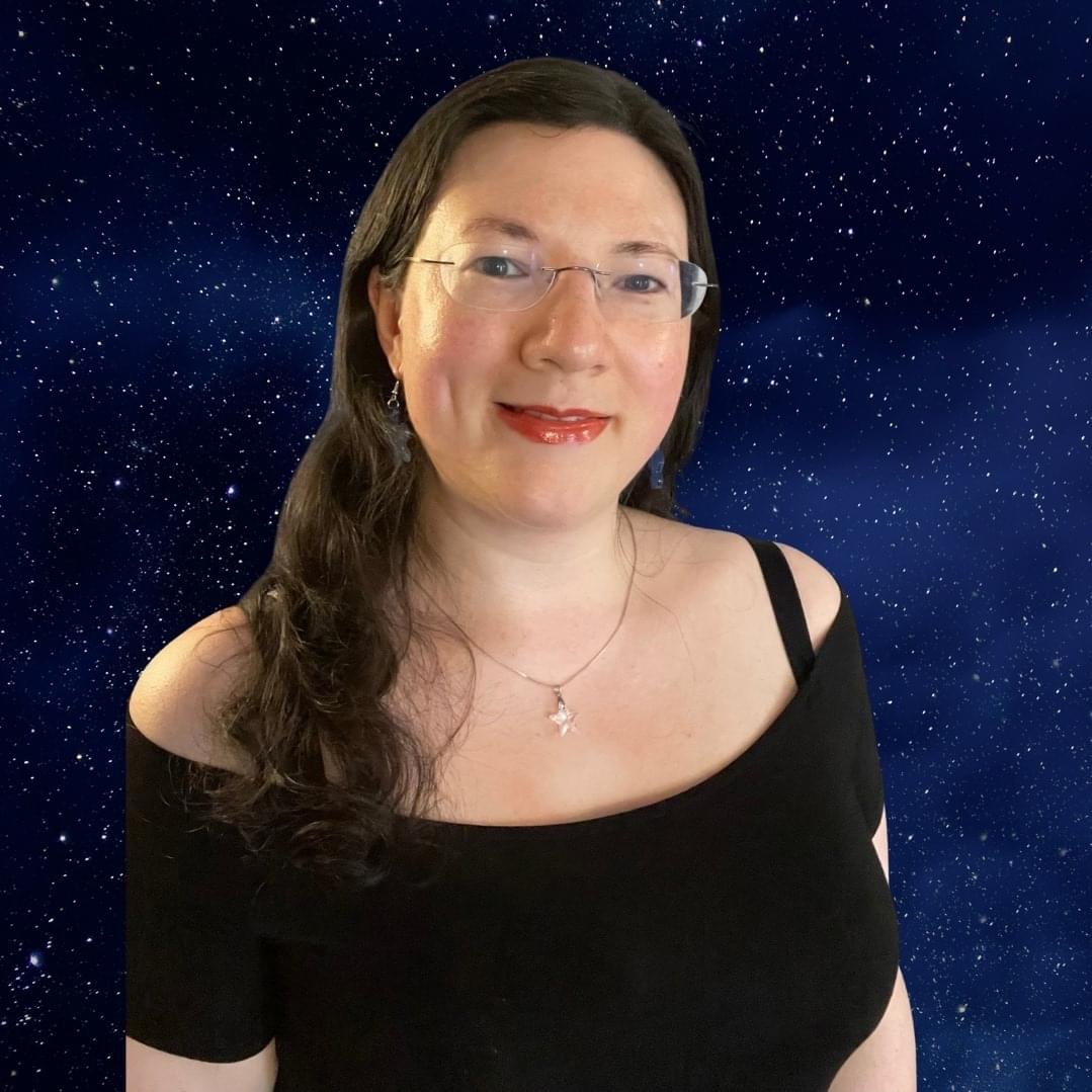 A selfie of Jen with toffee spice lip glaze on, way hair down, and an off the shoulder black top. on a blue galaxy themed background. proud to be an affiliate for Lyrical Host.