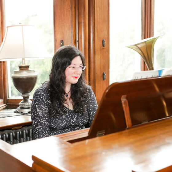 a picture of me playing the ornate piano at Chateau Rhianfa