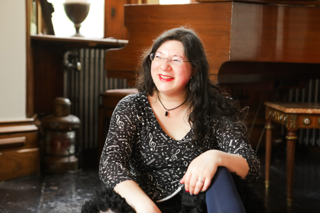 I had a Brand Photoshoot and it was so much fun! 10 a closer up photo of me smiling to the side by the piano