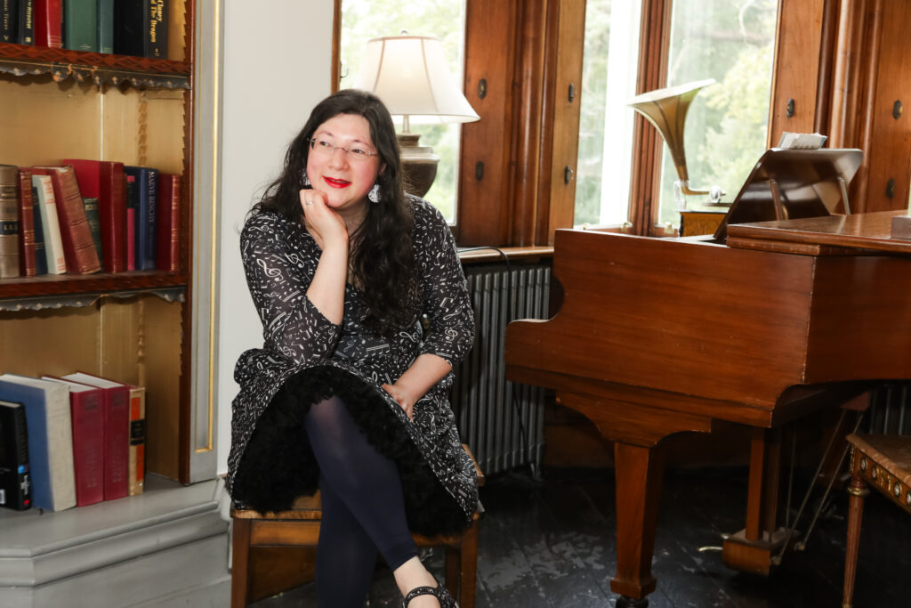 I had a Brand Photoshoot and it was so much fun! 13 a photo of me sat by the piano with my head leaning on my hand.