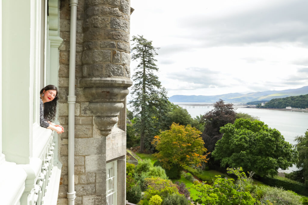 I had a Brand Photoshoot and it was so much fun! 15 a photo of me leaning out of the castle window, with the landscape in the background