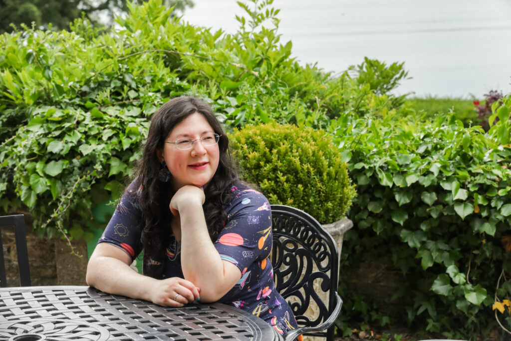 I had a Brand Photoshoot and it was so much fun! 22 a photo of me sat at a table and chairs on the terrace