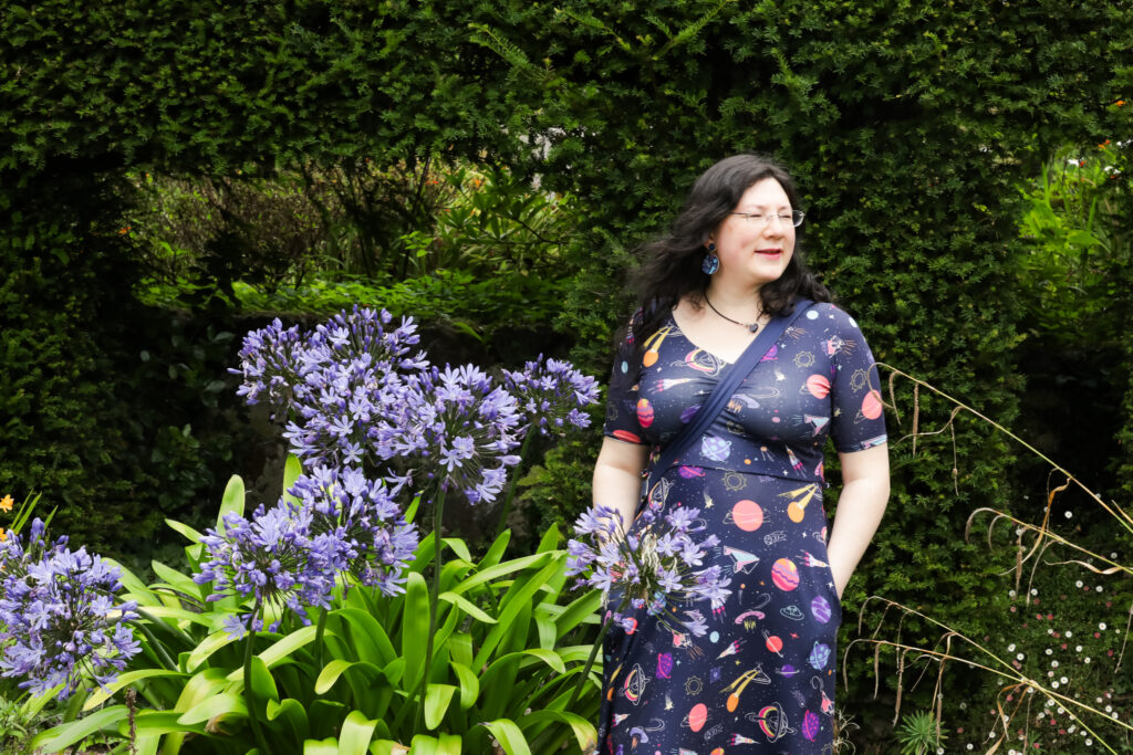 I had a Brand Photoshoot and it was so much fun! 29 a photo of me walking by some purple plants that match my dress