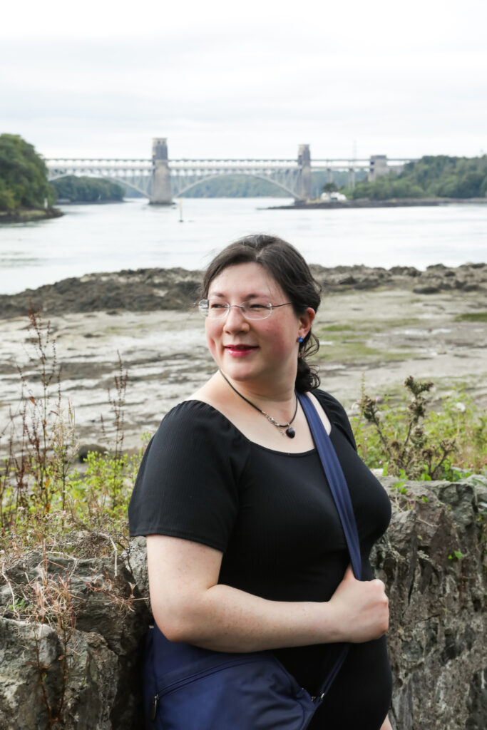I had a Brand Photoshoot and it was so much fun! 31 a photo of me on the belgian promenade in menai bridge, britannia bridge in the background