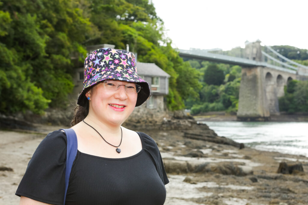 I had a Brand Photoshoot and it was so much fun! 34 me with a starry bucket hat on with menai bridge in the background
