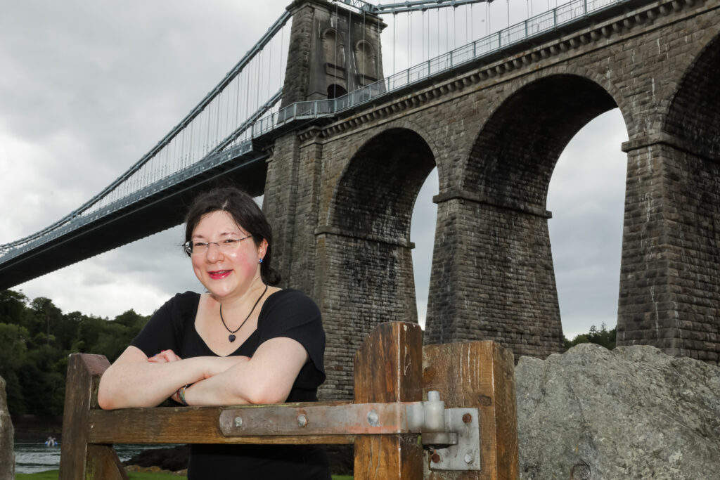 I had a Brand Photoshoot and it was so much fun! 36 I'm leaning against a gate with Menai Bridge as the backdrop.
