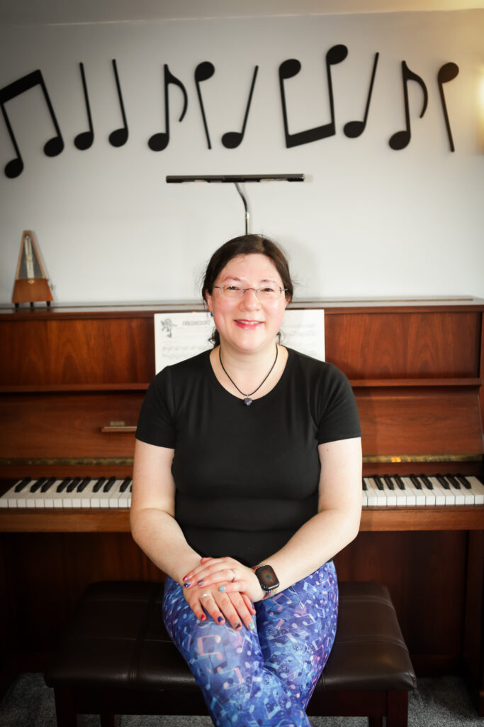 I had a Brand Photoshoot and it was so much fun! 38 Me smiling with my back to the piano.