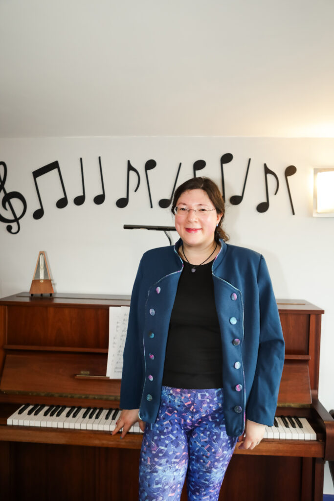 I had a Brand Photoshoot and it was so much fun! 40 I'm leaning against my piano wearing my tailor made jacket, and music themed leggings.