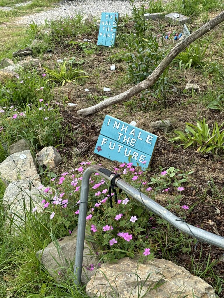 Speaker at a Brand New Yoga Festival- June 2024 - a Major 2024 Goal accomplished! 8 "Inhals the future" sign in the rockery