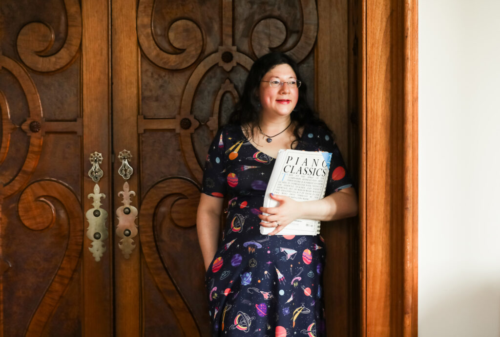 SOCIAL LINKS 2 to find out where I am on Social media, click the various icons below this image.
Jen is in her space dress glancing out of a window with the backdrop of an ornate door.