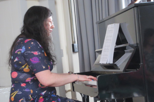 My First Summer Concert - 14/07/24 1 Me in my space dress playing for my first summer concert on a black upright piano