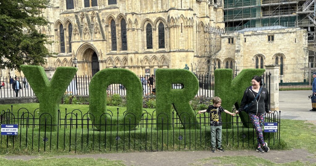 Making the most of the Summer Holidays 2024! 5 Hedge spelling the word "York" with me and my kid in front of it.