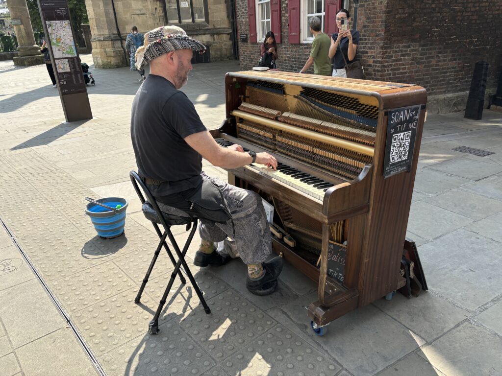 Making the most of the Summer Holidays 2024! 6 A busker playing his street piano in the centre of York