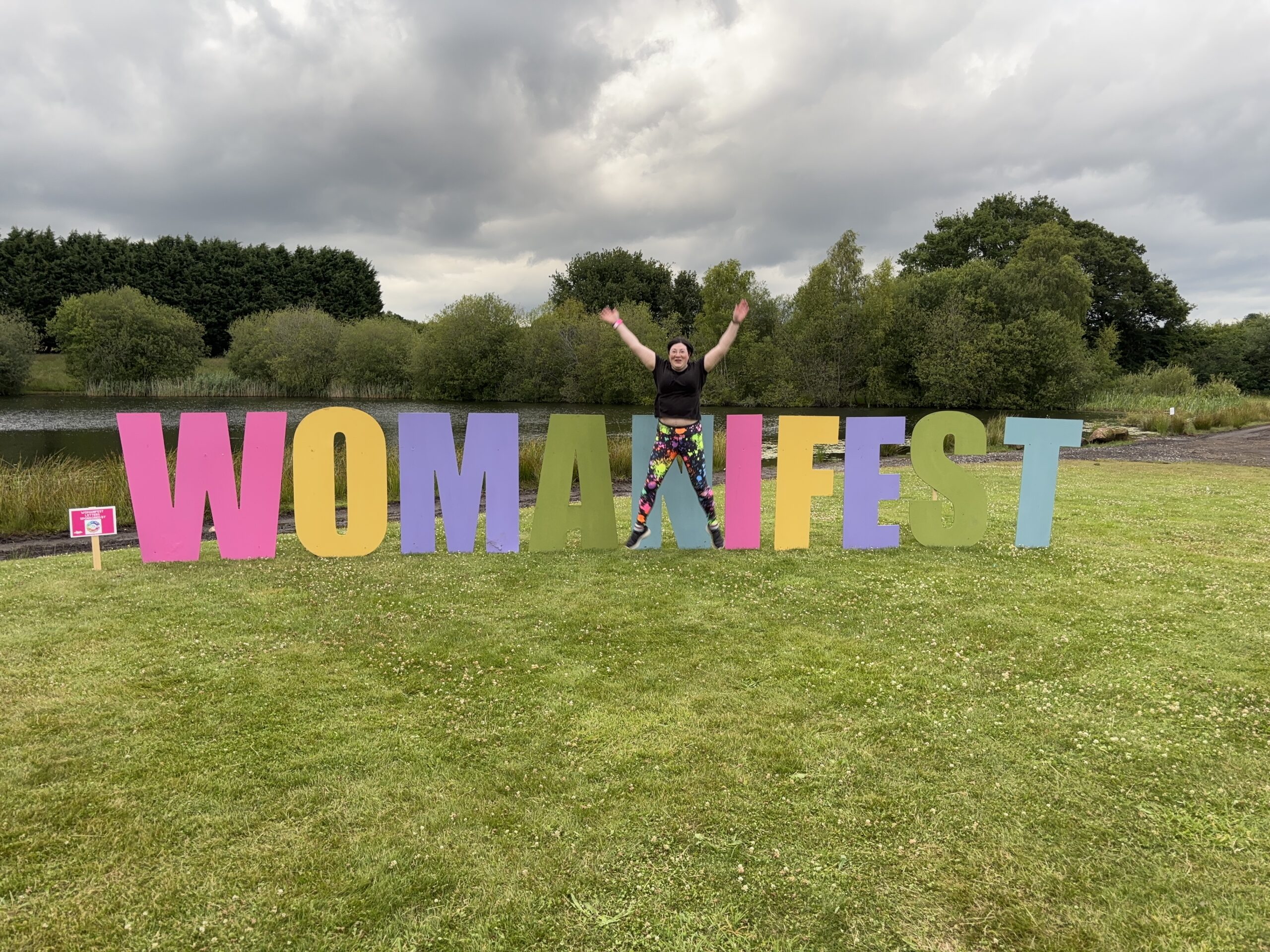 Festivals of 2025 Fulfilled & 3 Public Speaking Goals Smashed! 1 picture of me doing the star pose by the womanifest letters