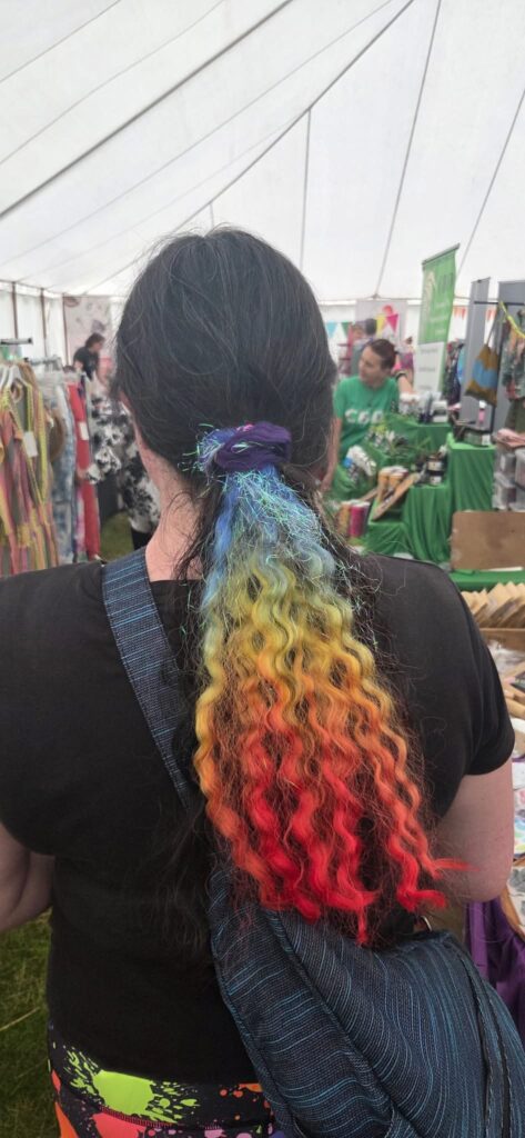 Festivals of 2025 Fulfilled & 3 Public Speaking Goals Smashed! 6 My hair with a rainbow piece in it.