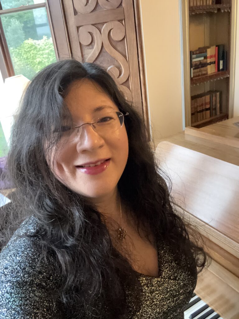 A Level Results, a 20+ year old Memory of Failure... 8 Selfie by the Chateau Rhianfa Piano Christmas eve 2024. hair down, touch of makeup, silver sparkly dress.