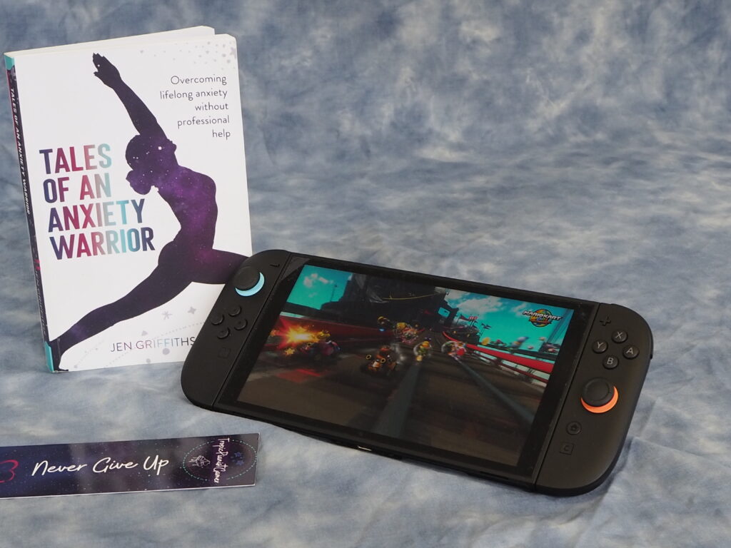 A Spontaneous Adventure to Learn Photography..! (and the Power of Networking) 21 A shot of my book, bookmark and switch 2 console against the cloud backdrop, showing Mario Kart World.